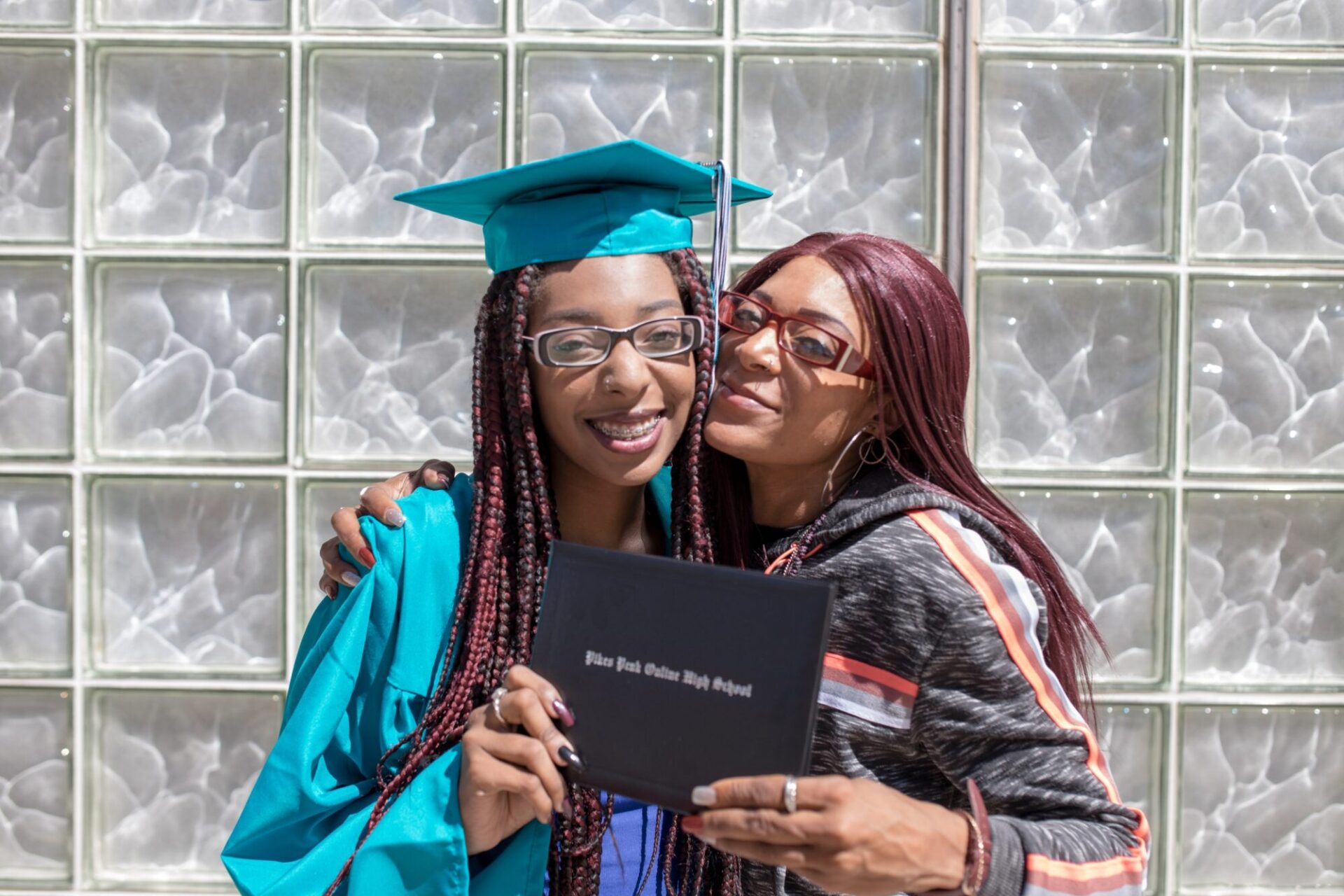 Graduate student and a family member smiling