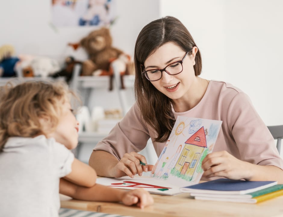 teacher with girl looking the paper