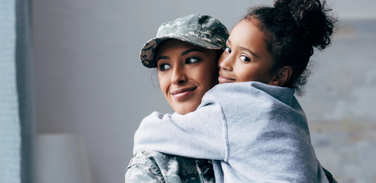 Military mother hugging her daughter